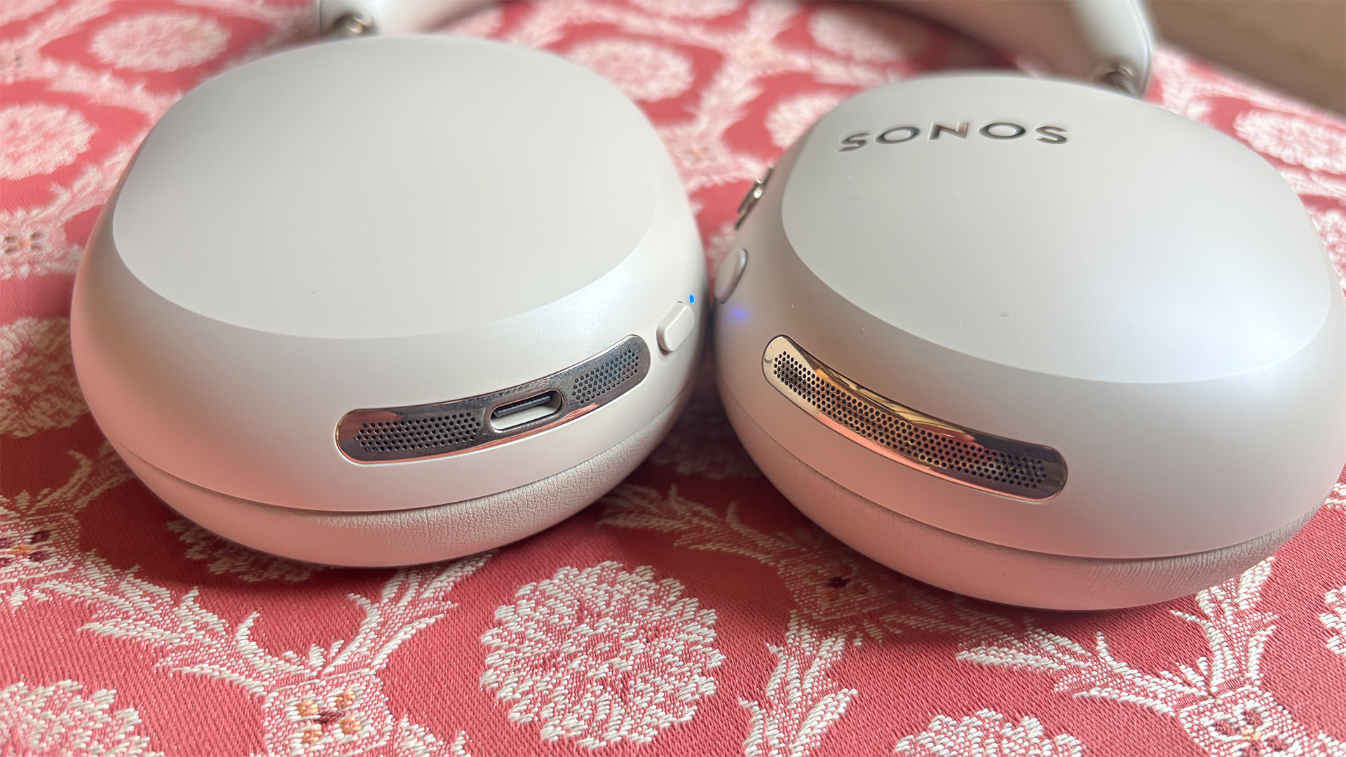 Sonos Ace Ultra wireless headphones face down on pink patterned fabric