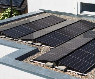 solar panels on flat roof showing concrete ballast to hold frame down