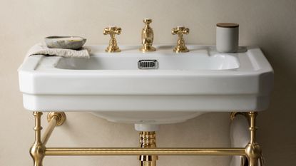 wash basin with silver colour tap and tiled wall