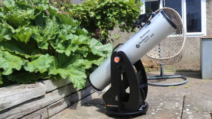 Celestron StarSense Explorer 8" Dobsonian telescope in a garden