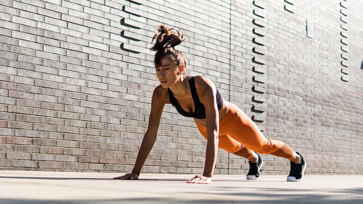 a woman in a high plank position