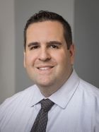 Headshot of Ryan Steele in front of gray background