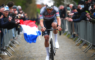 Race winner Mathieu Van Der Poel of Netherlands and Team Alpecin - Deceuninck competes passing through the Oude Kwaremont cobblestones sector while fans cheer during the 68th E3 Saxo Bank Classic - Harelbeke 2025 a 208.8km one day race from Harelbeke to Harelbeke / #UCIWT / on March 28, 2025 in Harelbeke, Belgium.