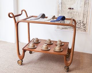 A trolley displaying P Johnson ties and solid travertine tea cups