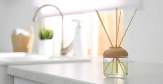 white kitchen countertop with a home fragrance diffuser to show scent scaping a home