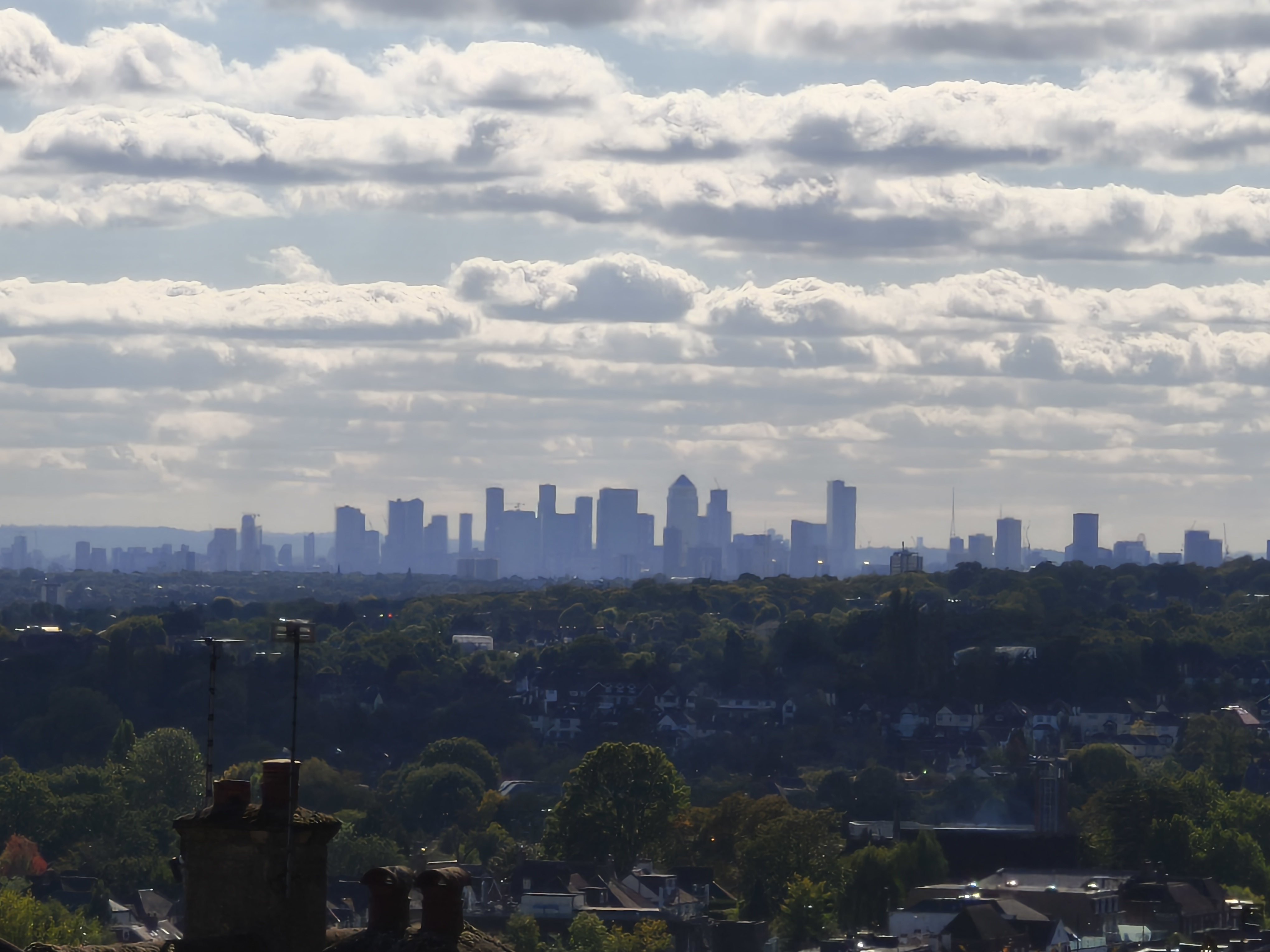 The Canary Wharf skyline against clouds