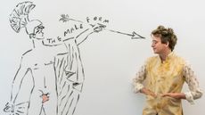 Luke Edward Hall in front of a mural he painted