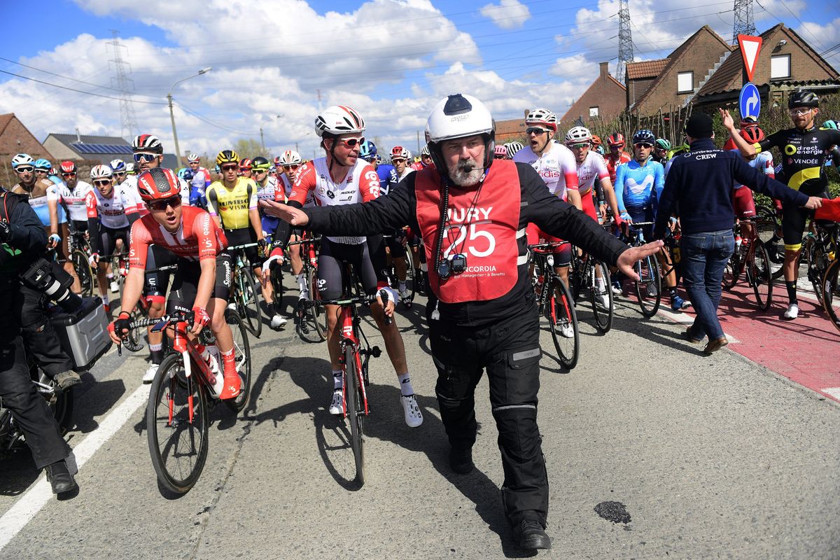 Race officials halt the men's race in Dwars door Vlaanderen