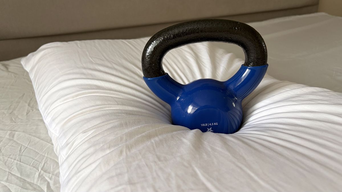 A close up of a 10lb kettlebell sitting on the Bearaby SoftForm Pillow