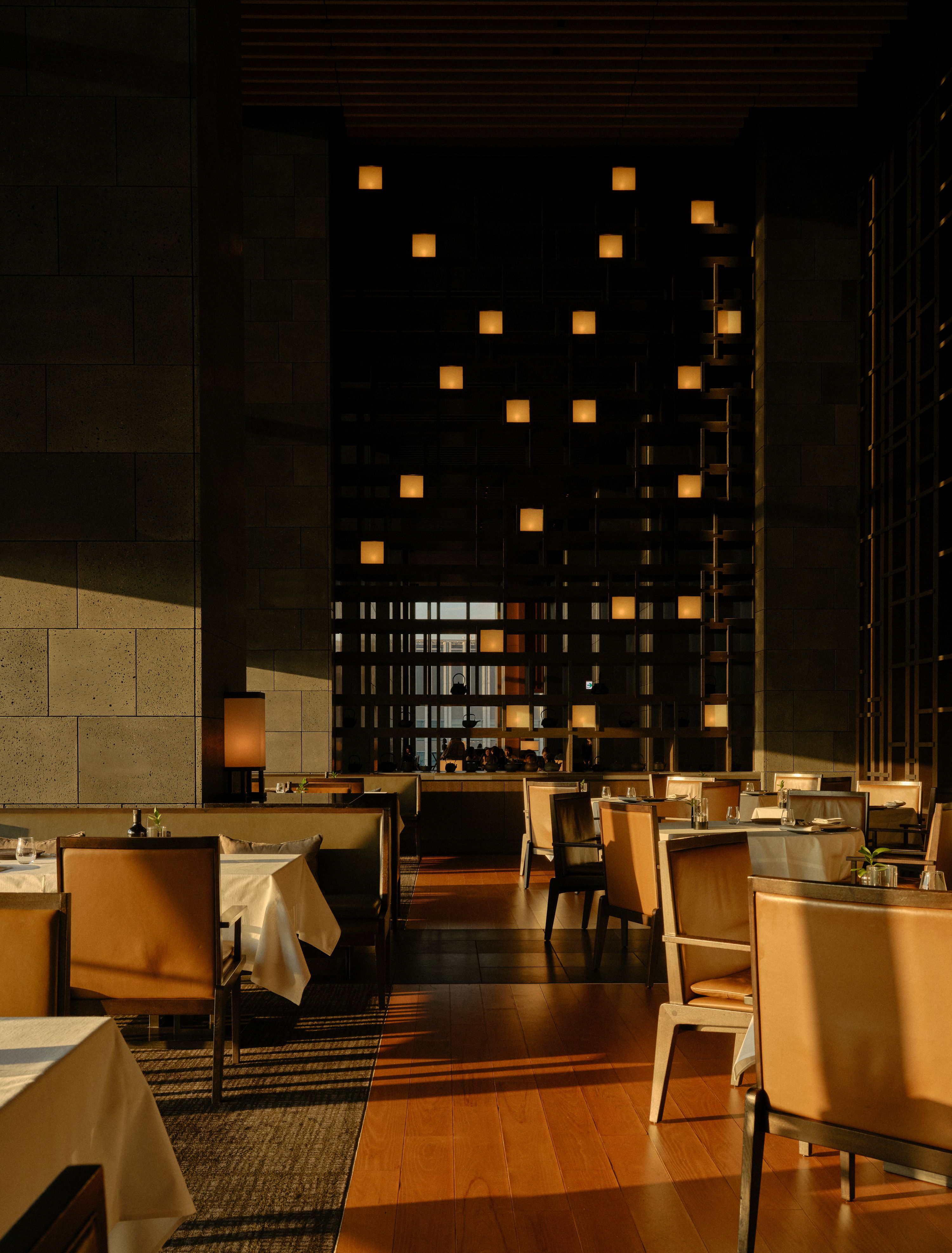 view of a serene hotel in tokyo, adorned with wooden furnishing, washi paper and natural stone touches