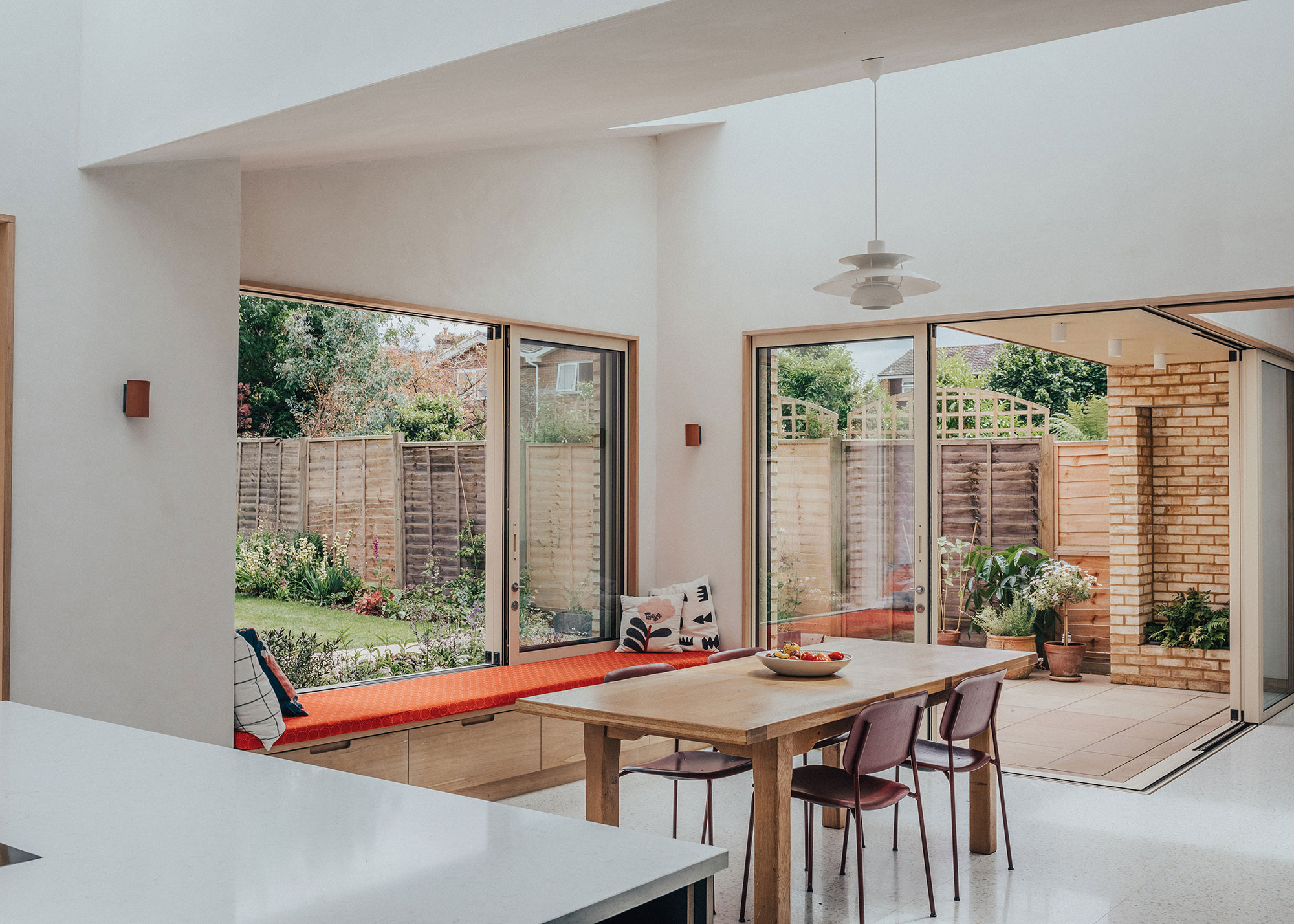 kitchen diner extension with sliding doors and windows with window seat with storage