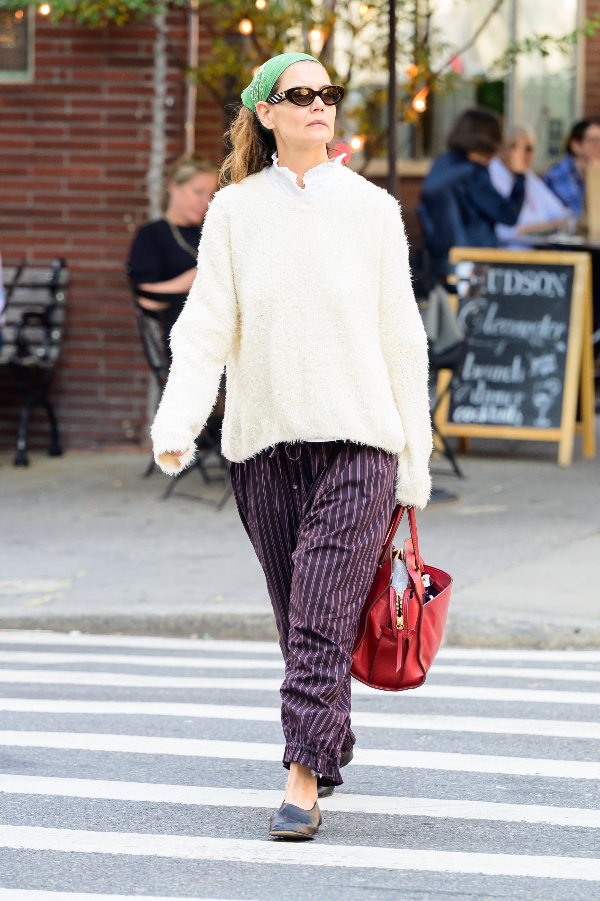 Katie Holmes was spotted in quirky color combinations, plus purple pinstripe pirate pants, ballet flats, and a tomato red bag