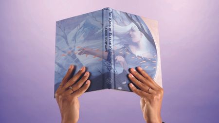 Two hands hold aloft a new book from Folio. 