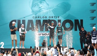 Carlos Ortiz celebrates on the podium at LIV Golf Houston