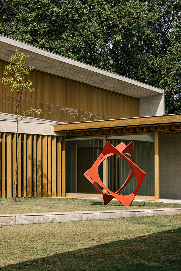 brazilian forest house exterior detail with red sculpture