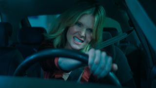 A determined Meghann Fahy grips her steering wheel angrily in Drop.