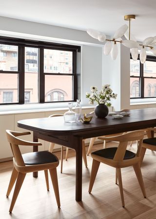 black dining table with timber chairs that extends