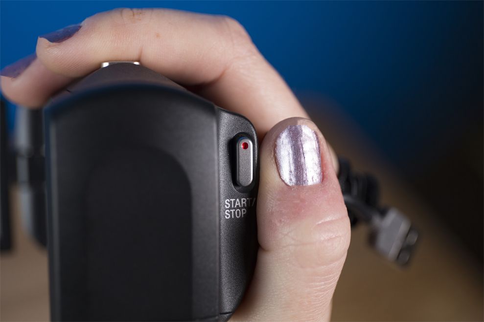 The button for recording video on the Sony Handycam HDR-CX405 is located where your thumb rests naturally.