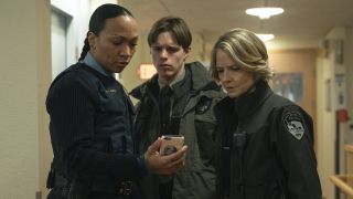 Peter, Danvers and Navarro looking at phone in True Detective: Night Country