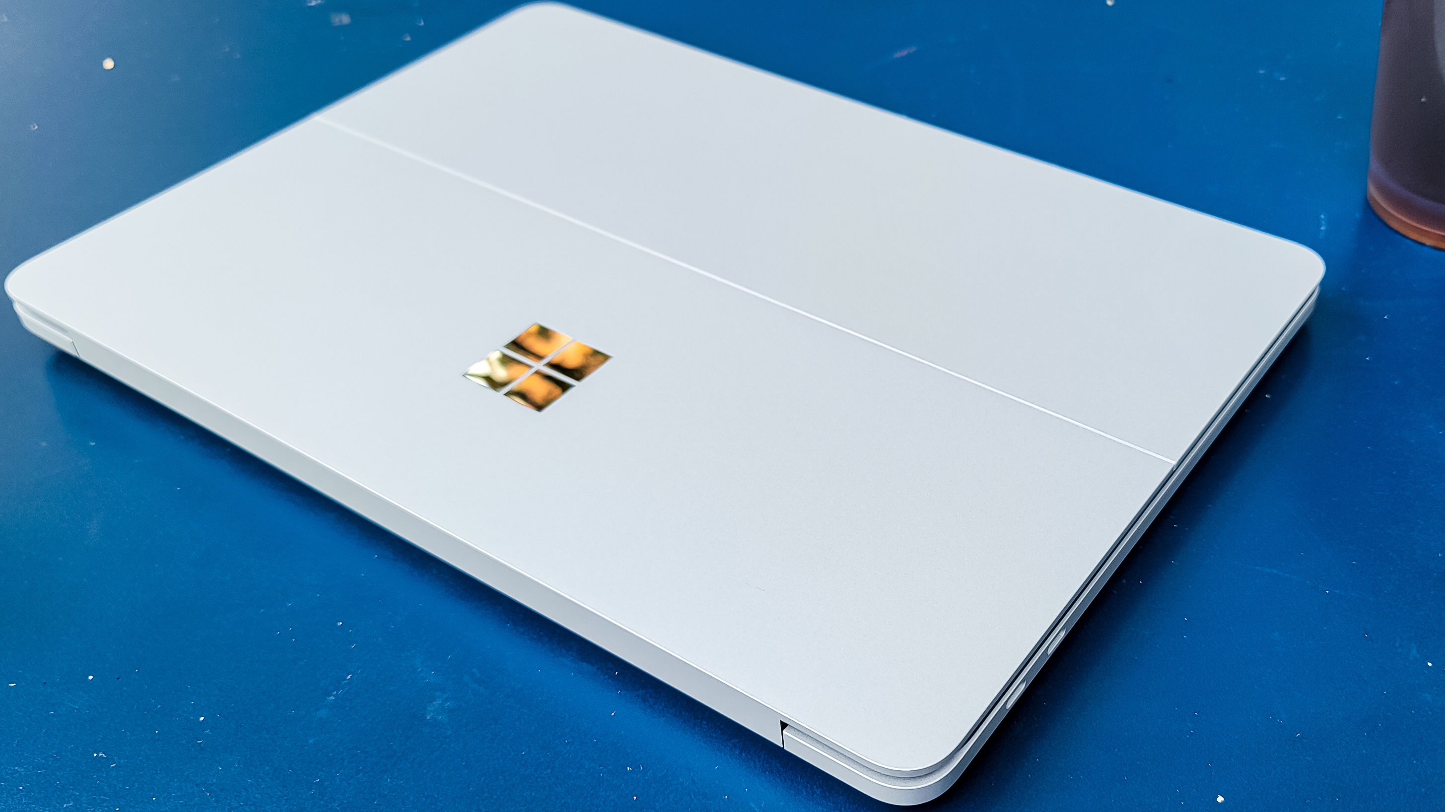 Surface Laptop Studio lid, on a Blue table