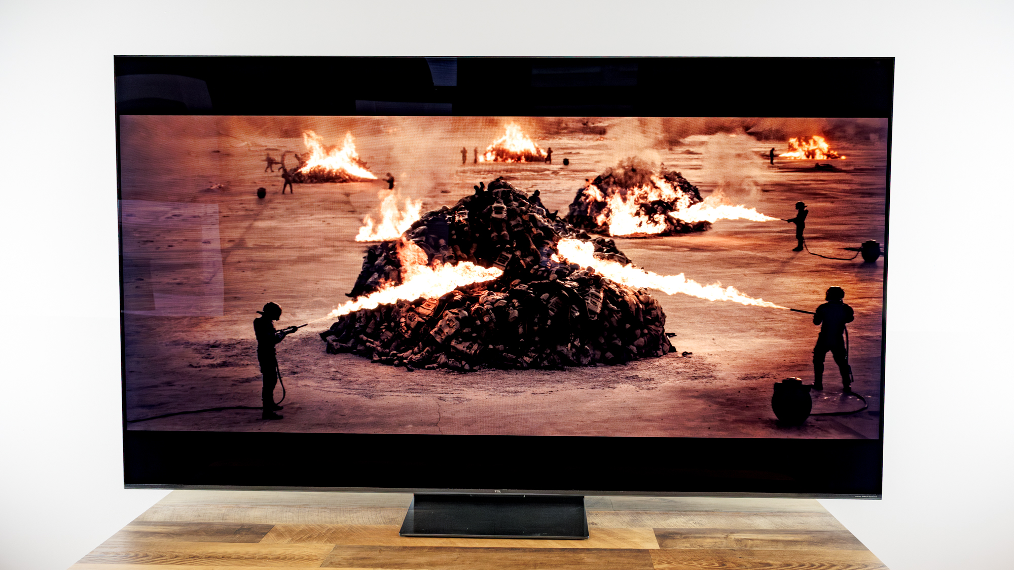 TCL QM7L 75-inch TV on a desk