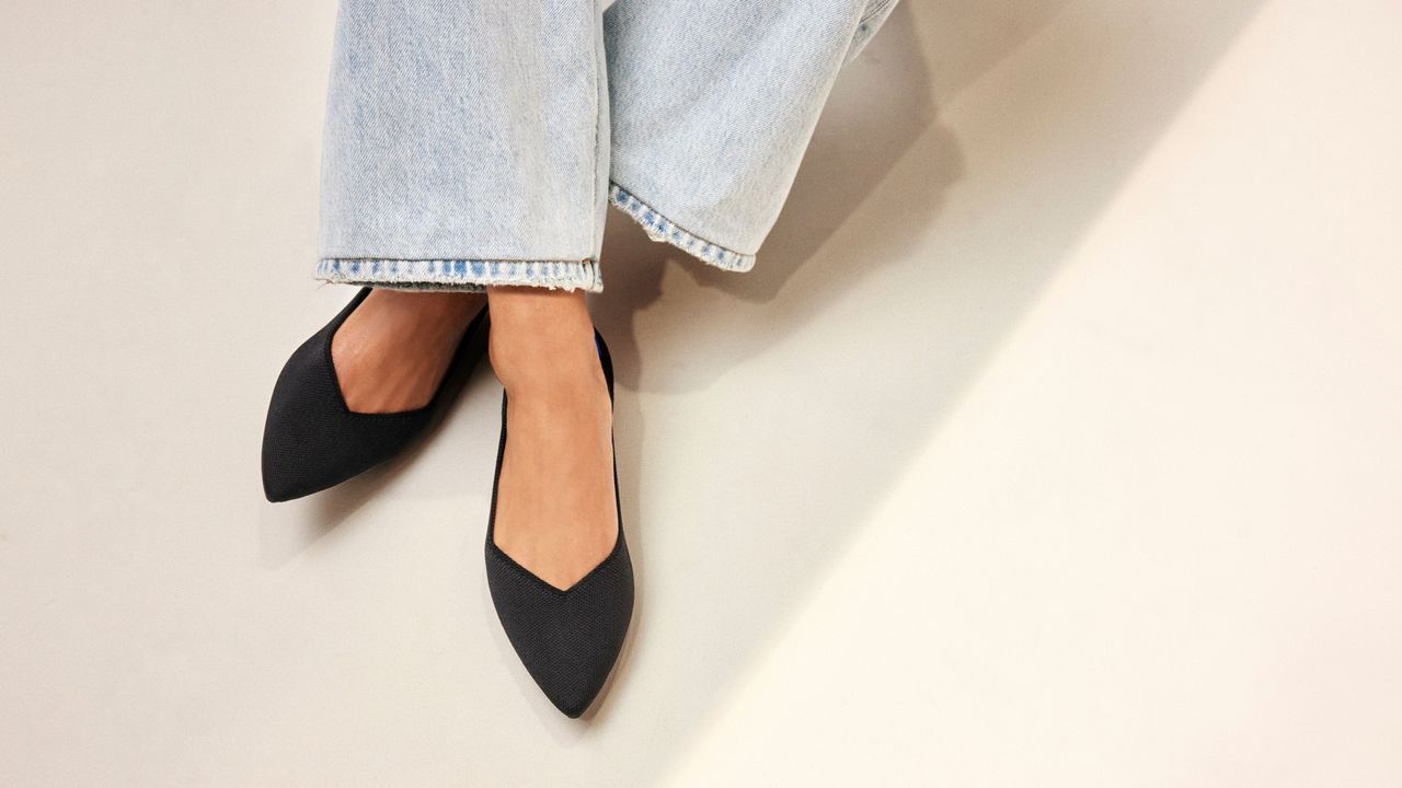 woman wearing Rothy&#039;s The Point II flats in black