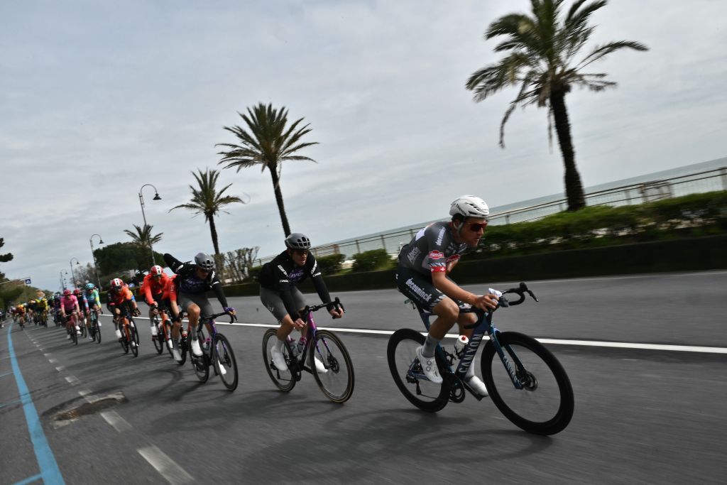 The peloton rides by the sea near Genoa during the Milan - Sanremo one-day classic cycling race, on March 22, 2025. (Photo by Marco BERTORELLO / AFP)