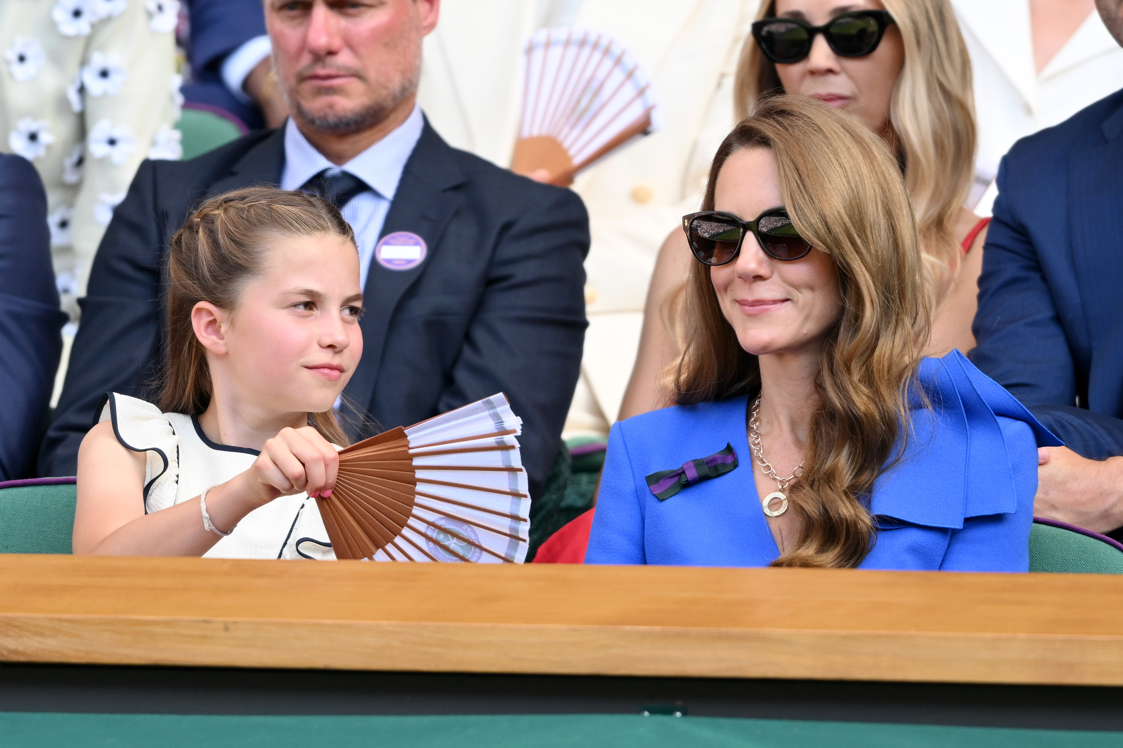 Princess Charlotte fans her mom Kate Middleton at Wimbledon as they watch the tennis tournament during a heat wave