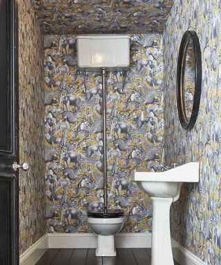 Bathroom with patterned wallpapered ceiling in yellow black and white