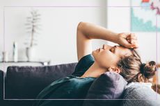 Sad woman laying on a sofa