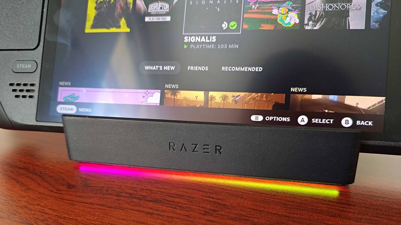 Close up of Razer Handheld Dock front logo with Steam Deckj in cradle and SteamOS on display.