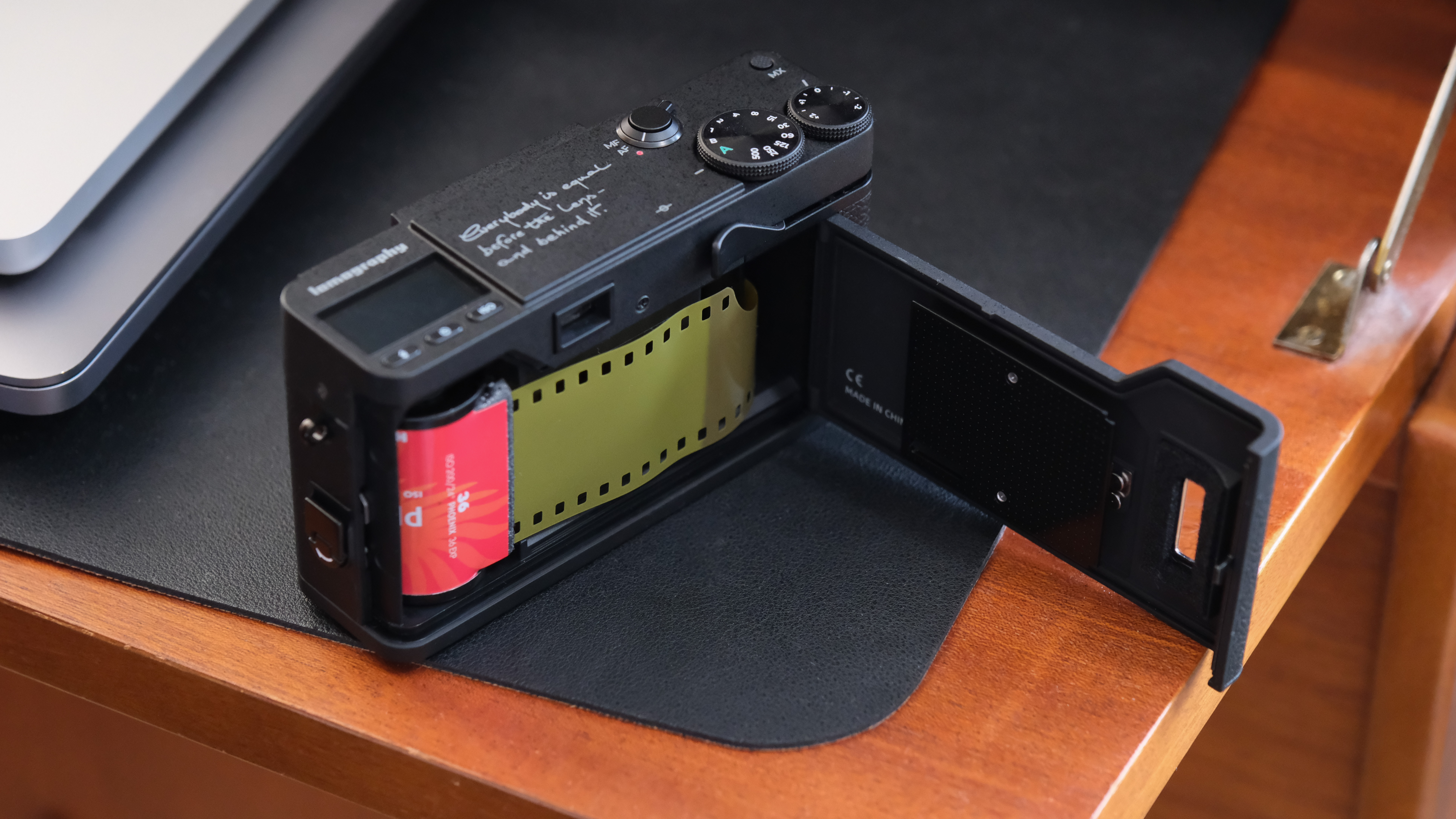 Lomography Lomo MC-A camera with the film door open and a film loaded inside