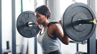 Woman lifting weights in gym