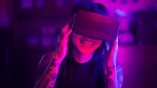 A woman smiles using a headset in the metaverse. 