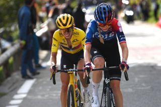 Kasia Niewiadoma in the yellow jersey rides with Évita Muzic on the final day of the Tour de France Femmes