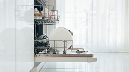 An open dishwasher in a kitchen