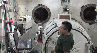 Japanese astronaut Koichi Wakata talks to the robot Kirobo aboard the International Space Station on Dec. 6, 2013.