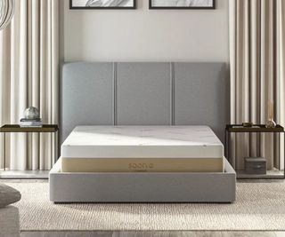 Saatva Contour5 Mattress on a bed against a white wall.