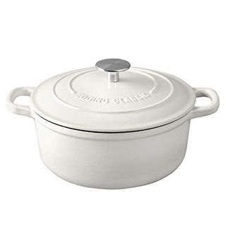 A white enamel dutch oven pan with a lid