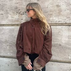 Influencer wearing a stand-collar brown suede jacket
