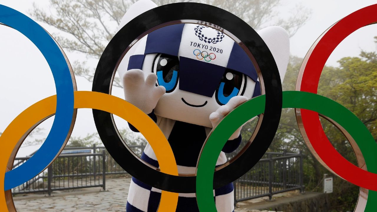 Tokyo 2020 mascot Miraitowa poses with the Olympic Rings 