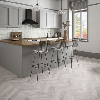 grey kitchen with grey chevron flooring