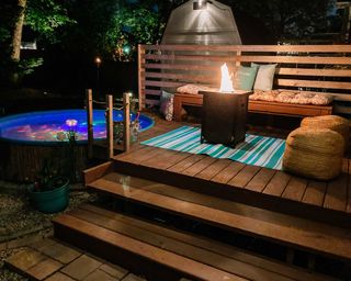 stock tank pool in decking with fire pit