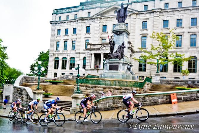 Five riders in the break climb on wet roads