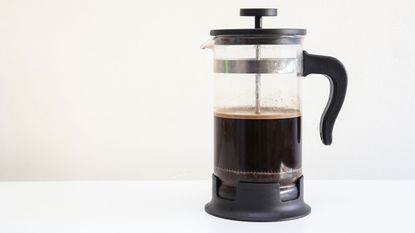 A French press on a white background