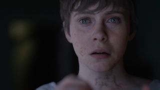 A screenshot of a woman with tears in her eyes in the OD trailer.