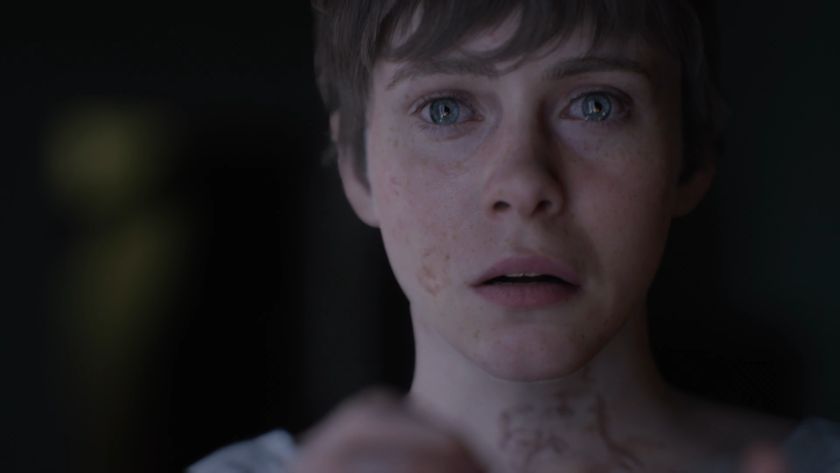 A screenshot of a woman with tears in her eyes in the OD trailer.