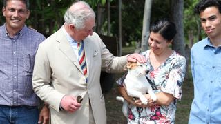 Prince Charles, Prince of Wales is seen petting a dog on a tour of the organic farm 'Finca Marta' on March 26, 2019 in Havana, Cuba. Their Royal Highnesses have made history by becoming the first members of the royal family to visit Cuba in an official capacity.