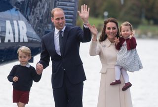 Catherine, Duchess of Cambridge, Prince William, Duke of Cambridge, Prince George of Cambridge and Princess Charlotte of Cambridge wave to wellwishers as they depart Victoria
