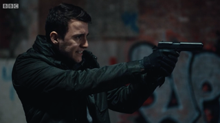 Ryan Pilkington aims a gun at Kate in Line of Duty